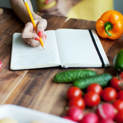 Person writing in recipe book